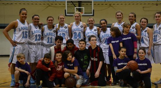 The Lasell College Women's Basketball Team with the Plowshares After School Program in Newton Public Schools.